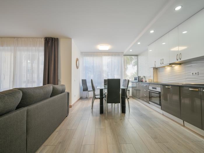 Open plan kitchen with dining table for 6 and modern appliances