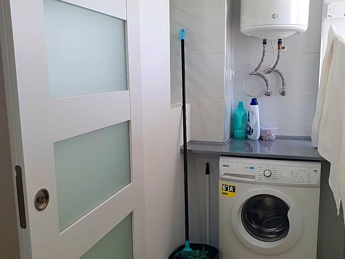 Utility room with washing machine and clothesline