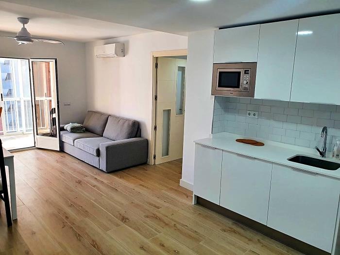 Living room with open plan kitchen with vitro ceramic, microwave